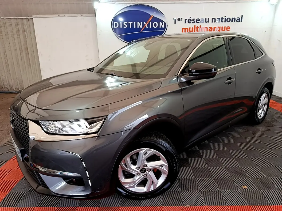 DS7 Crossback gris foncé vu en 3/4 avant droit, mettant en valeur sa calandre distinctive et ses phares LED.