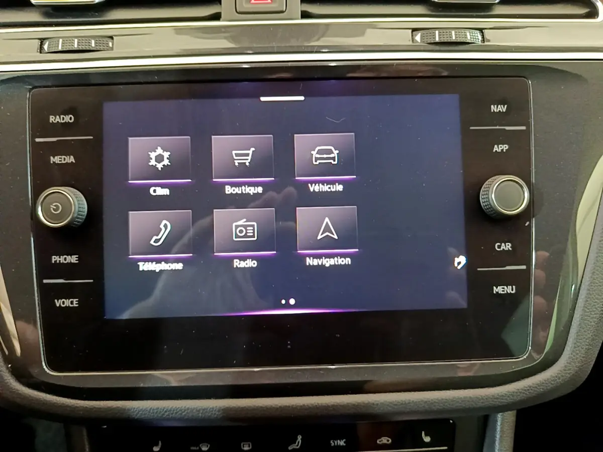 Écran tactile central du Volkswagen Tiguan 2021 affichant les options clim, boutique, véhicule, téléphone, radio et navigation.