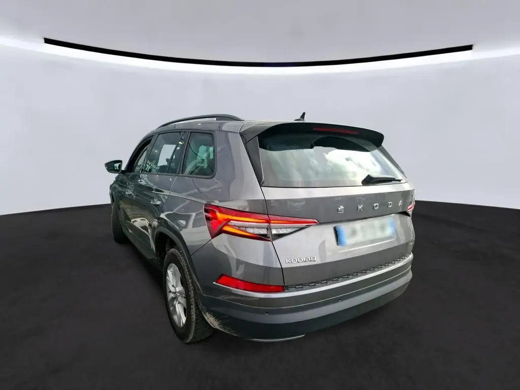 Vue de profil côté gauche d'un Skoda Kodiaq gris 2023 avec jantes alu 17 pouces dans un garage.