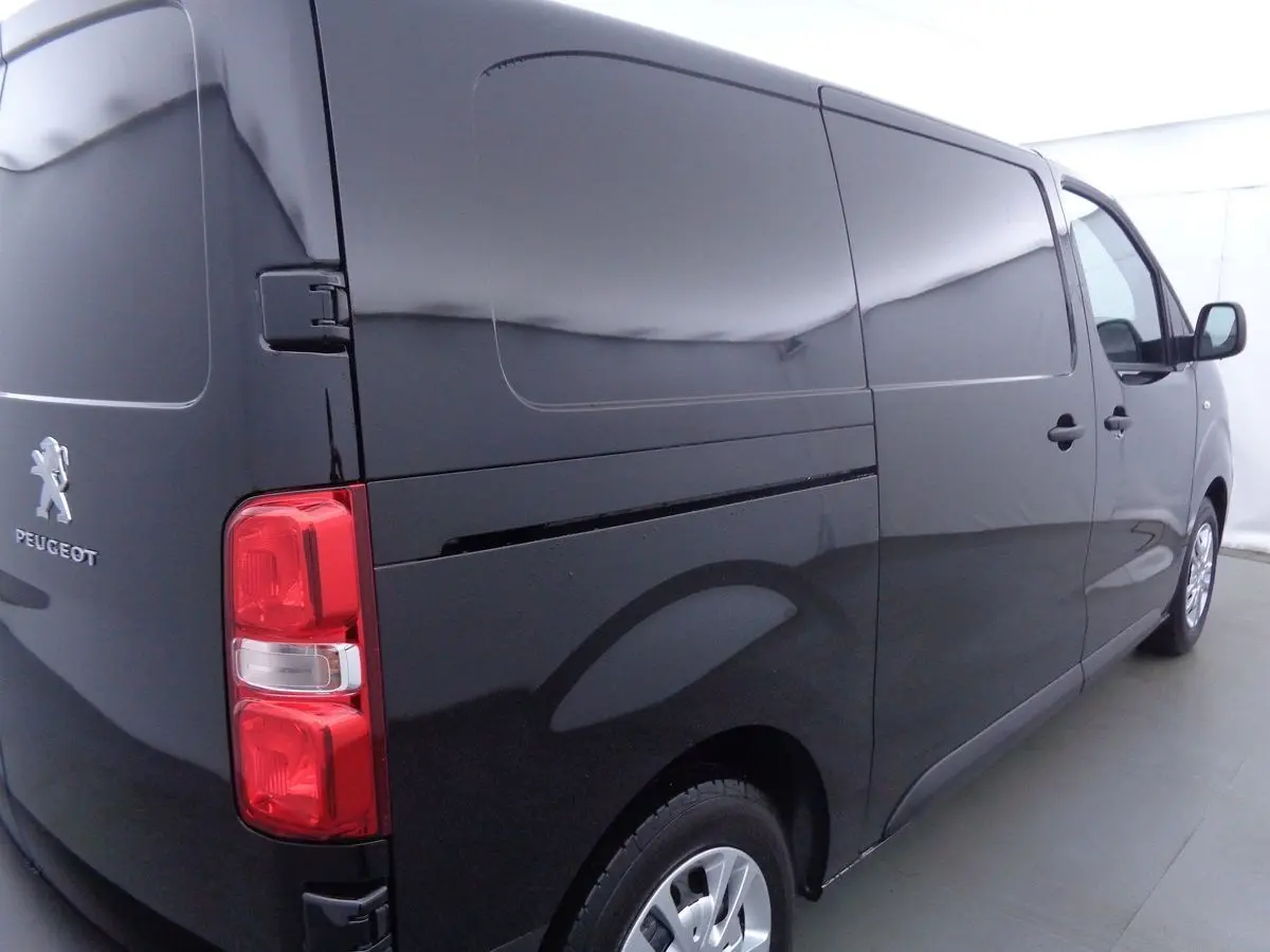 Vue 3/4 arrière droite d'un Peugeot Expert Fourgon noir métal 2022 avec feux arrière rouges et carrosserie lisse.
