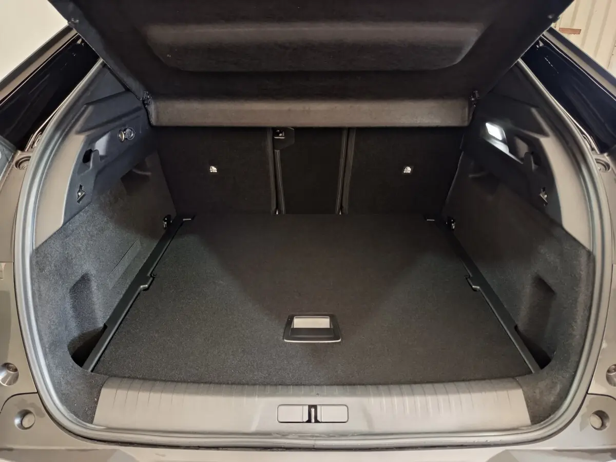 Coffre ouvert du Peugeot 3008 gris foncé, vue arrière montrant un espace de chargement spacieux et bien fini.
