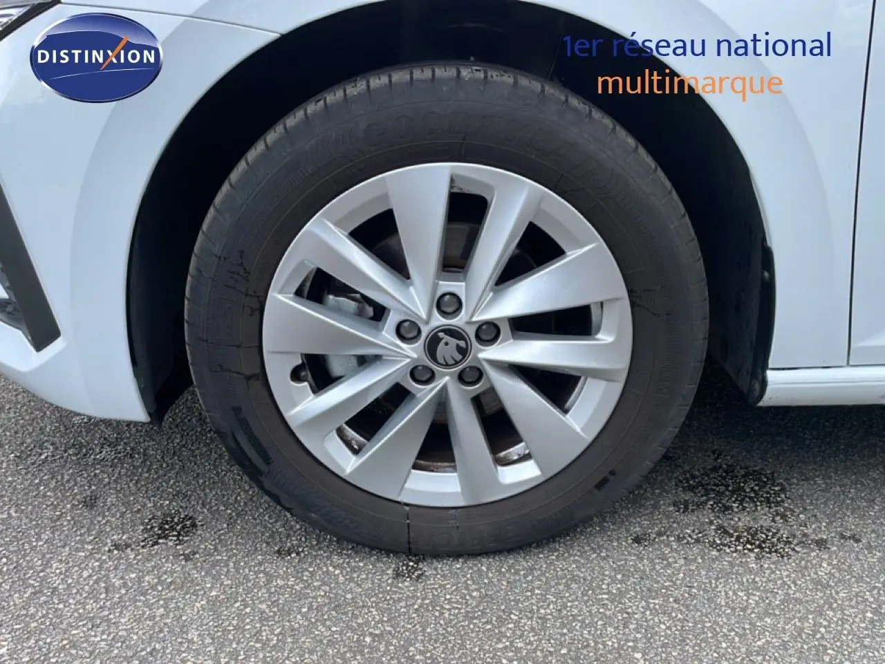 Gros plan sur la roue avant gauche d'une Skoda Scala blanc glacier avec jante alliage 16 pouces.