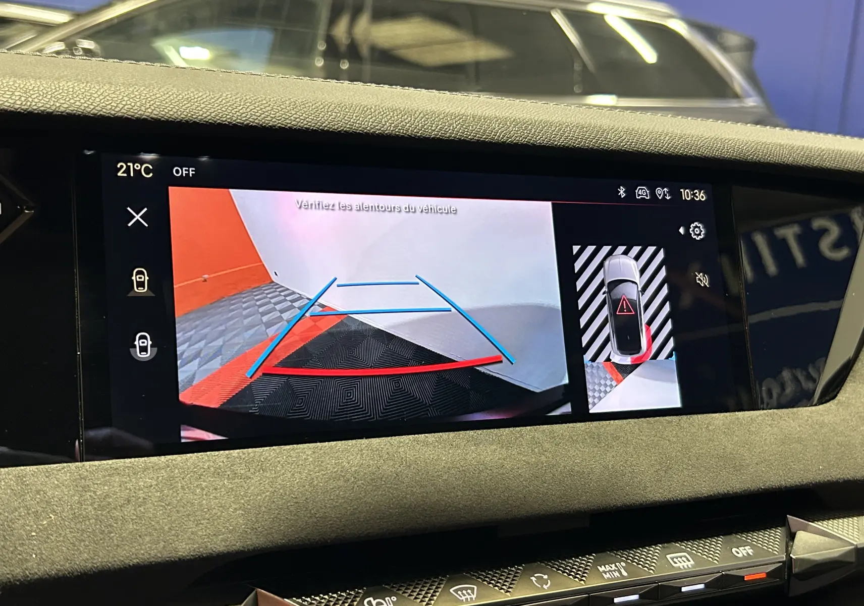Écran de caméra de recul du DS4 2024 noir Perla Nera affichant les lignes de guidage et l'alerte de proximité arrière.