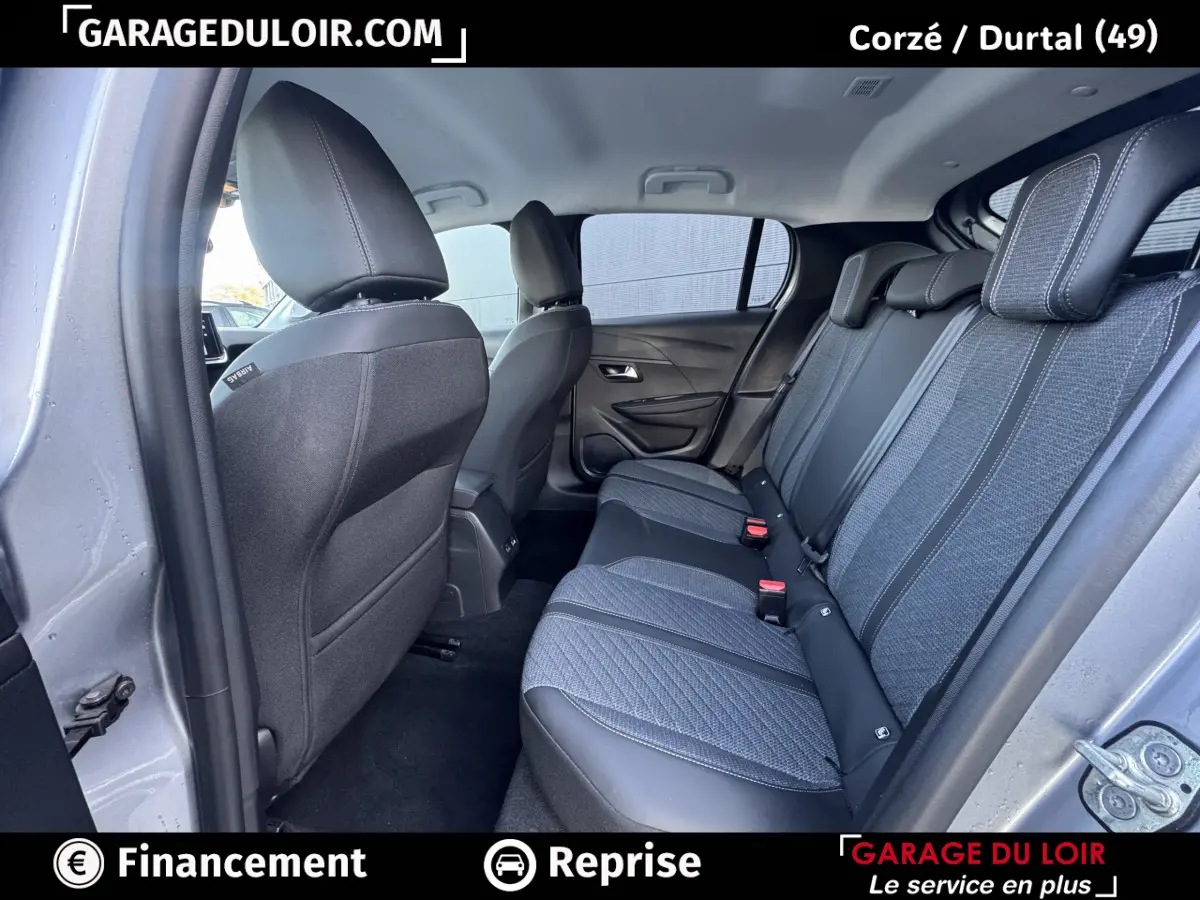 Vue intérieure côté droit montrant la banquette arrière grise et noire du Peugeot 208 Hybrid 110 e-DCS6 Allure 2025.
