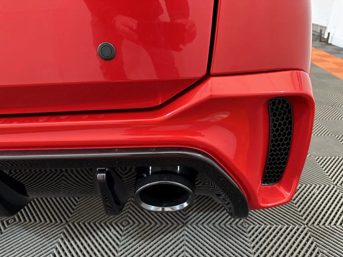 Gros plan sur l'échappement et le diffuseur arrière rouge vif de l'AIXAM AMBITION 0.5 CITY COUPE GTI E5+ 2025.