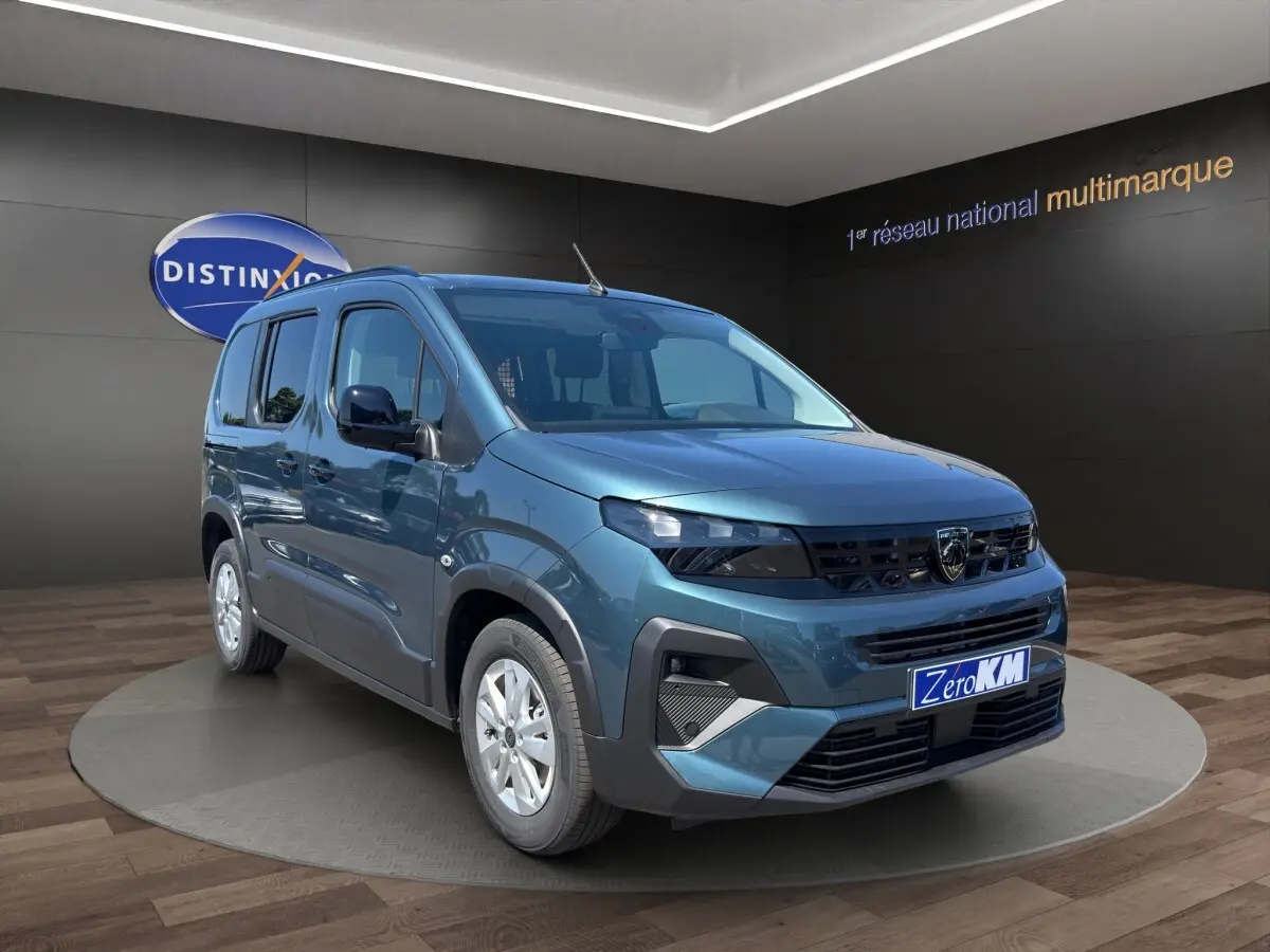 Peugeot Rifter bleu vue 3/4 avant droit en showroom avec calandre noire et jantes argentées.