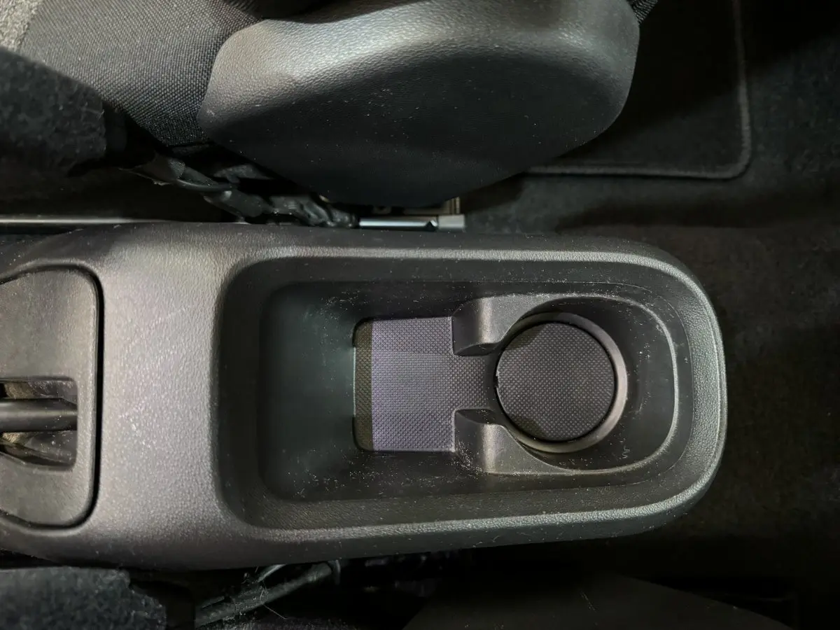 Gros plan sur le porte-gobelet central noir de l’habitacle d’une Citroën C3 PureTech 2019, finition Shine Business.