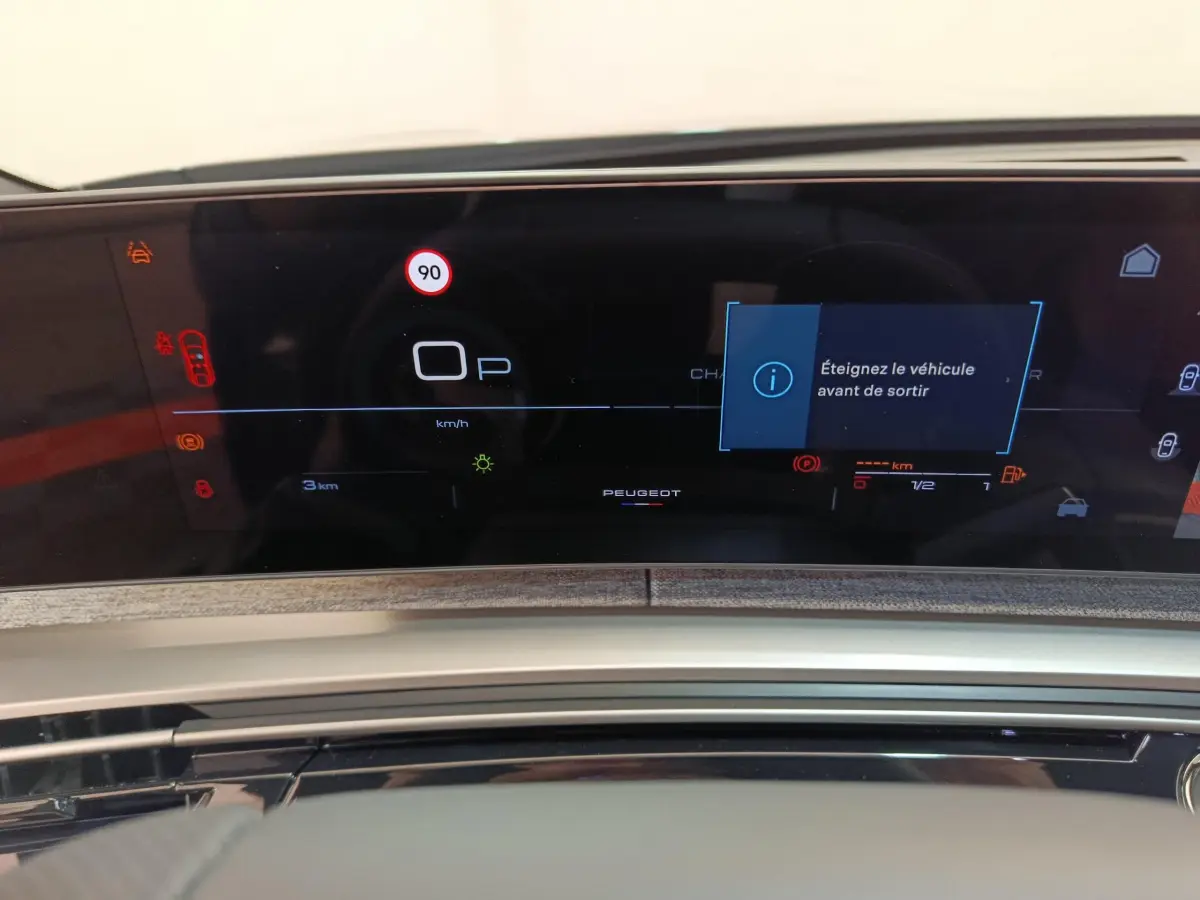 Tableau de bord numérique du Peugeot 3008 1.2 Hybrid 145 GT affichant un message d'arrêt avant sortie.