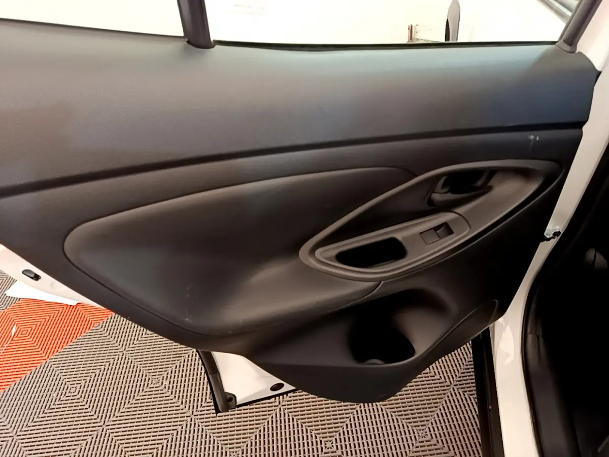 Gros plan sur la porte arrière droite noire intérieure du Toyota Yaris Cross blanc 2022, avec poignée et commande fenêtre.