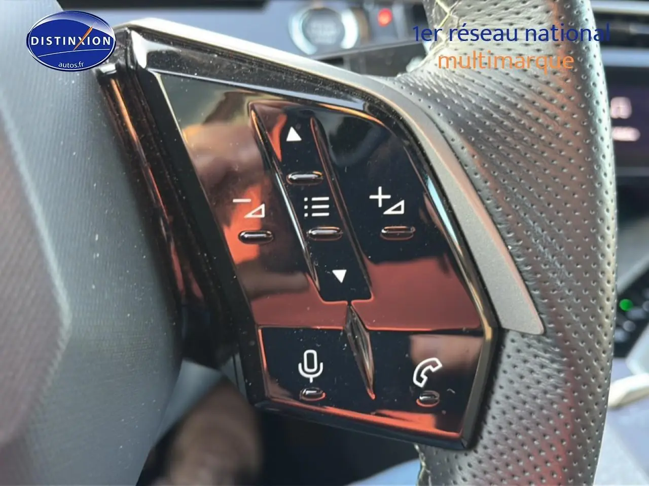 Gros plan sur les commandes vocales et téléphone du volant cuir perforé d’un Peugeot 3008 gris, version 2025.