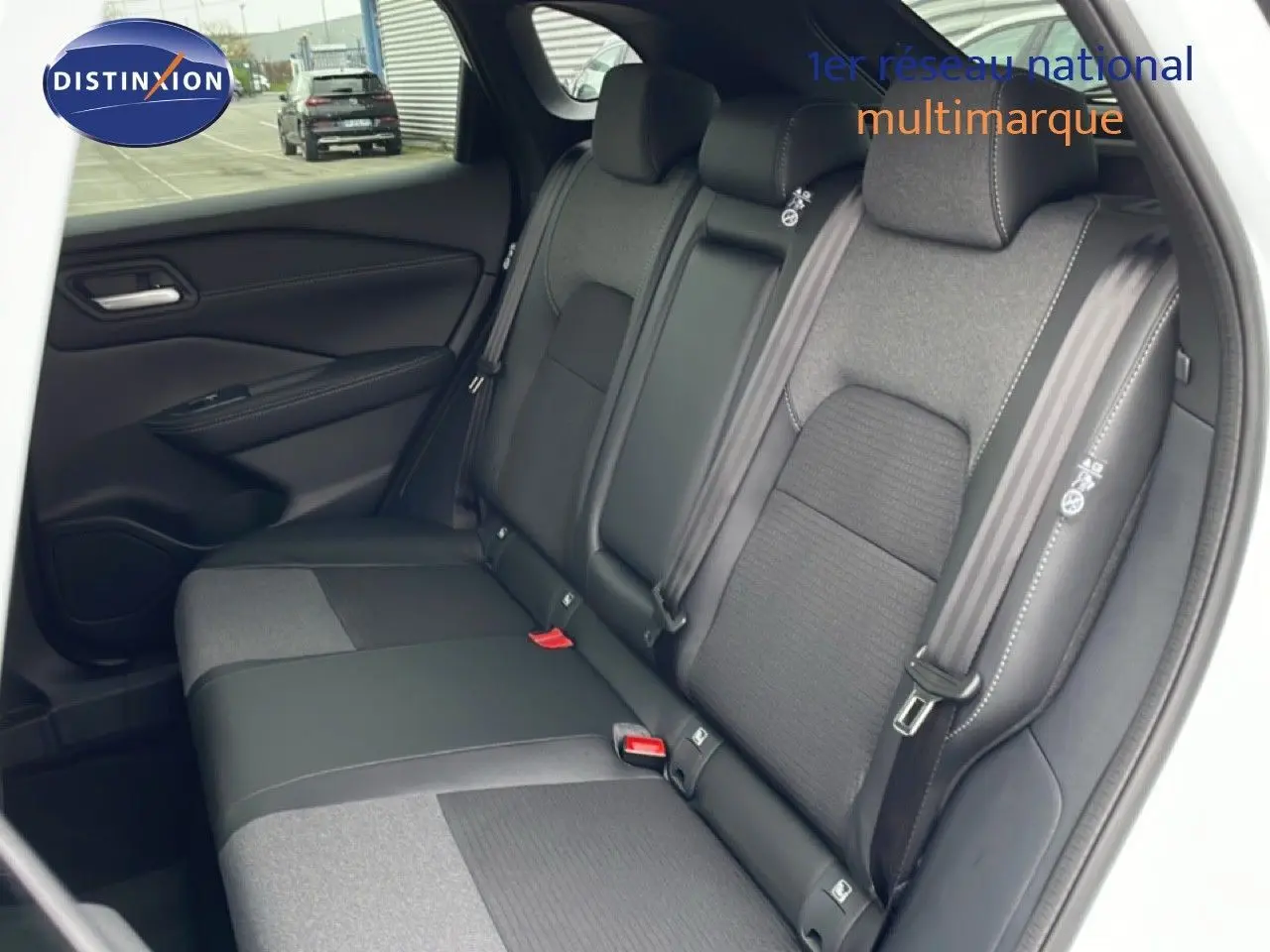 Vue intérieure côté droit montrant la banquette arrière en tissu et cuir noir du Nissan Qashqai blanc nacré 2025.