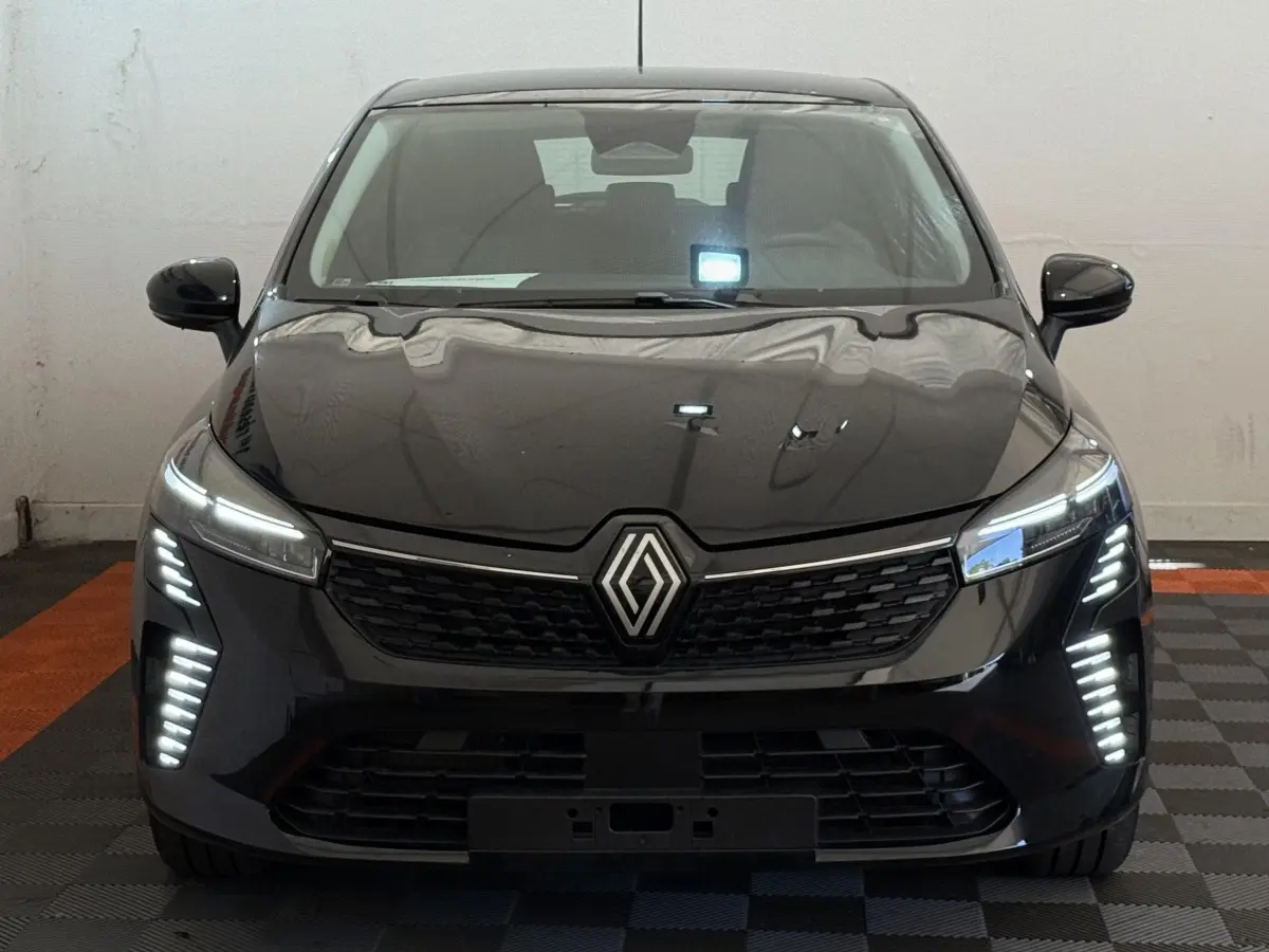 Vue frontale d'une Renault Clio noire 2025 avec feux LED verticaux et calandre noire distinctive.