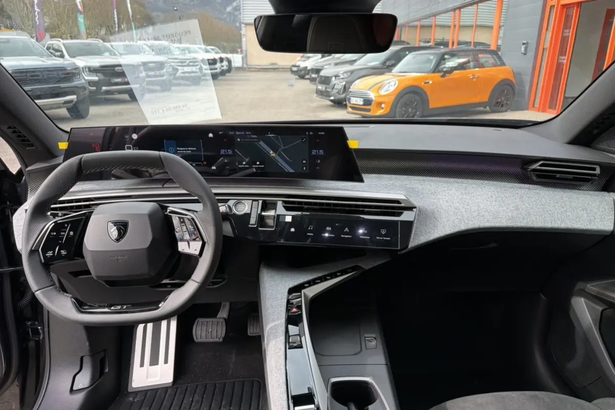 Tableau de bord et volant du Peugeot 3008 Hybrid 145 GT Alcantara vus de face, intérieur moderne avec finitions grises et noires.