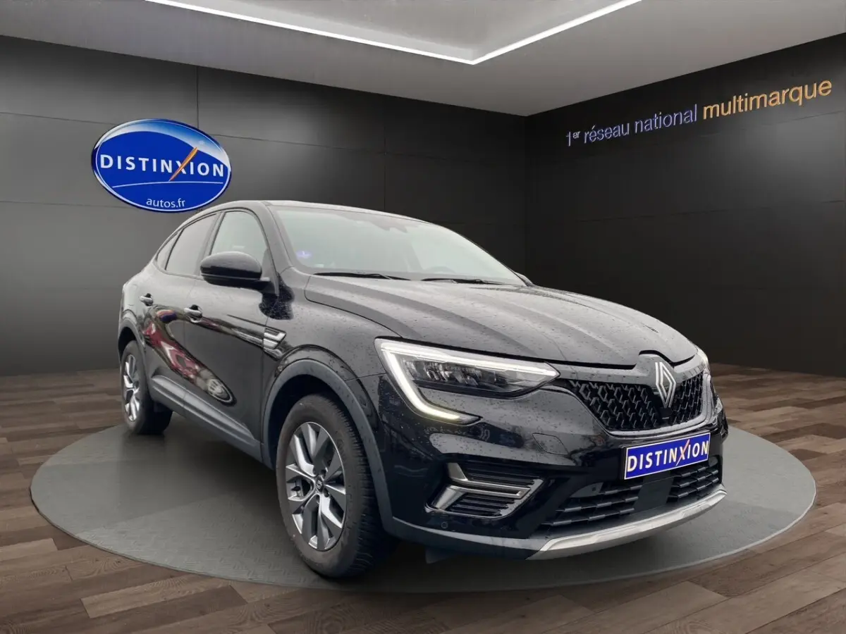 Renault Arkana noir vue 3/4 avant droit, feux LED allumés, calandre noire et jantes alliage visibles.