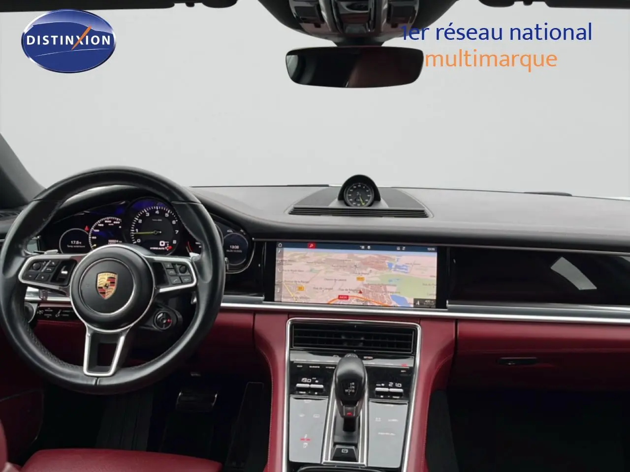 Vue intérieure du tableau de bord et volant noir d'une Porsche Panamera 4 E-Hybrid 2017 avec sellerie cuir bordeaux.