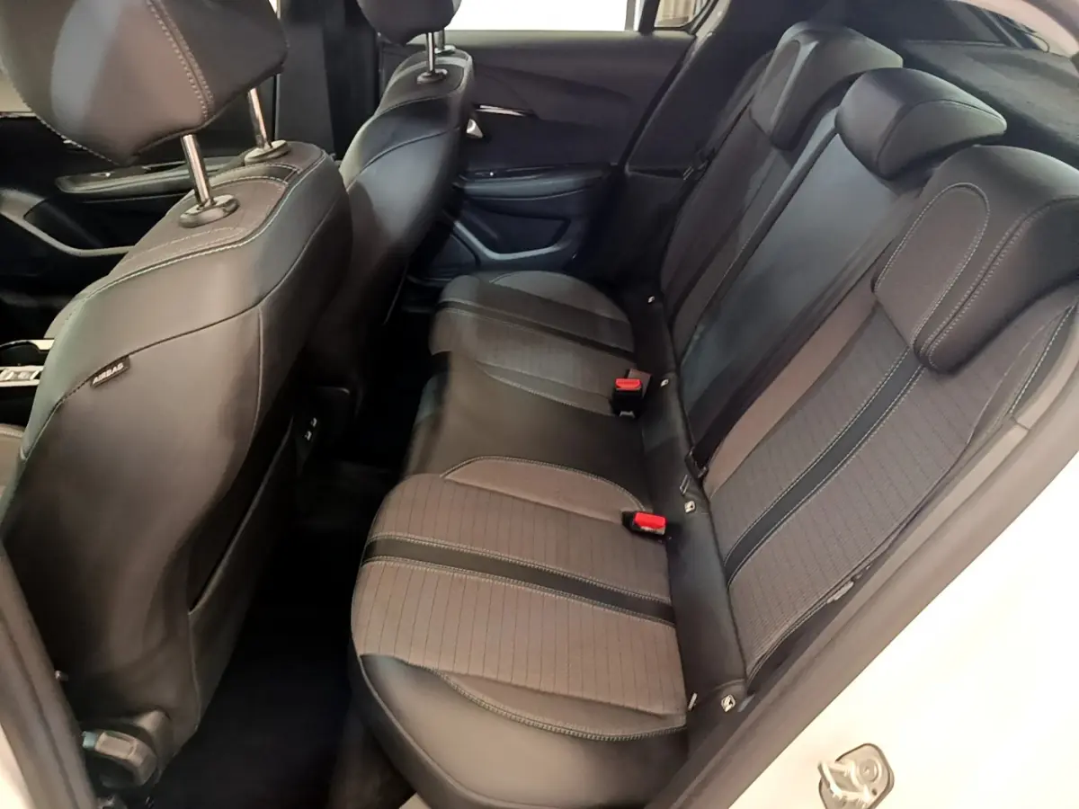 Vue intérieure côté droit des sièges arrière noirs en tissu et cuir d'une Peugeot 208 blanche PureTech 100 S&S Allure Business 2020.