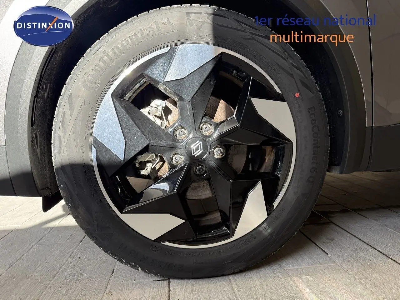 Gros plan sur la roue avant droite du Renault Captur gris Cassiopée Métal avec jante noire et argentée design moderne.