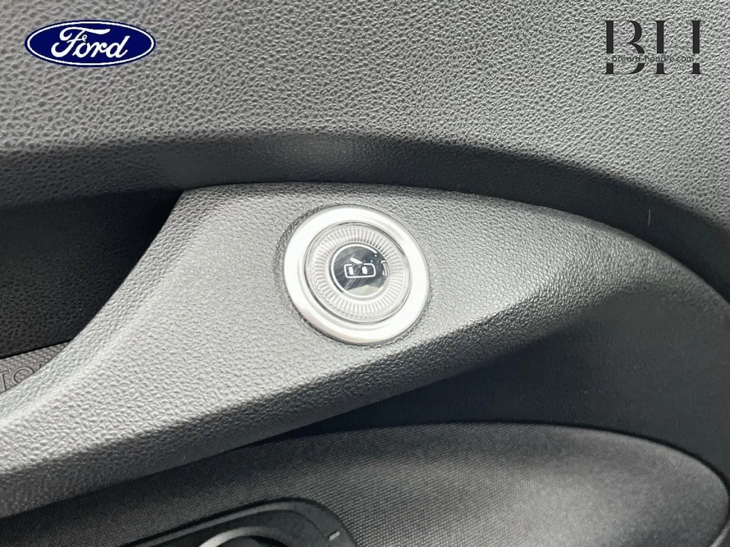 Bouton de verrouillage centralisé en gros plan sur la portière intérieure noire d'une Fiat 500 Ice White pastel.