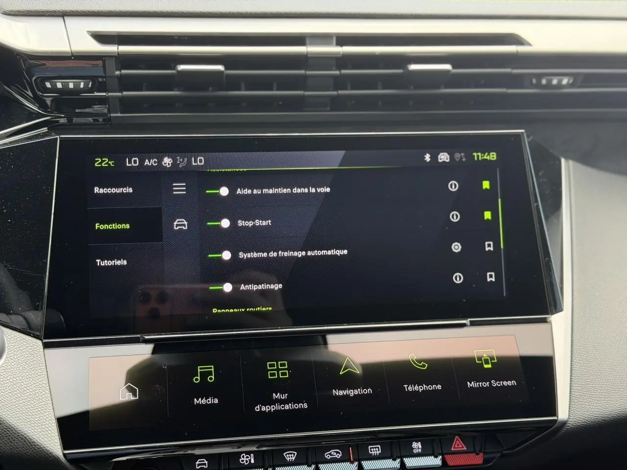 Écran tactile central de la Peugeot 308 gris Selenium montrant les options d’aide à la conduite en intérieur.
