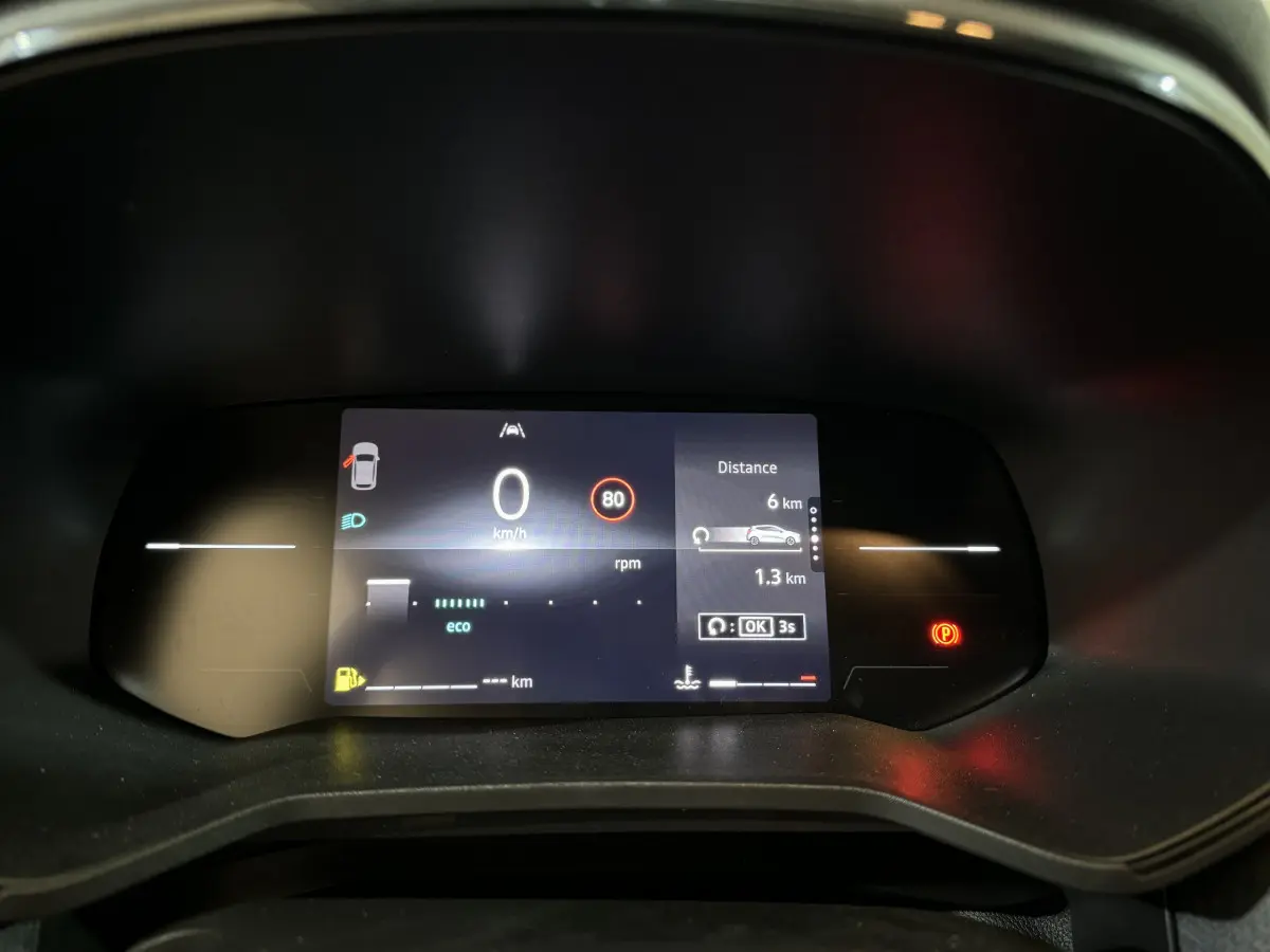 Combiné d'instruments numérique de la Renault Clio gris clair 2025 affichant vitesse, distance et alertes au tableau de bord.