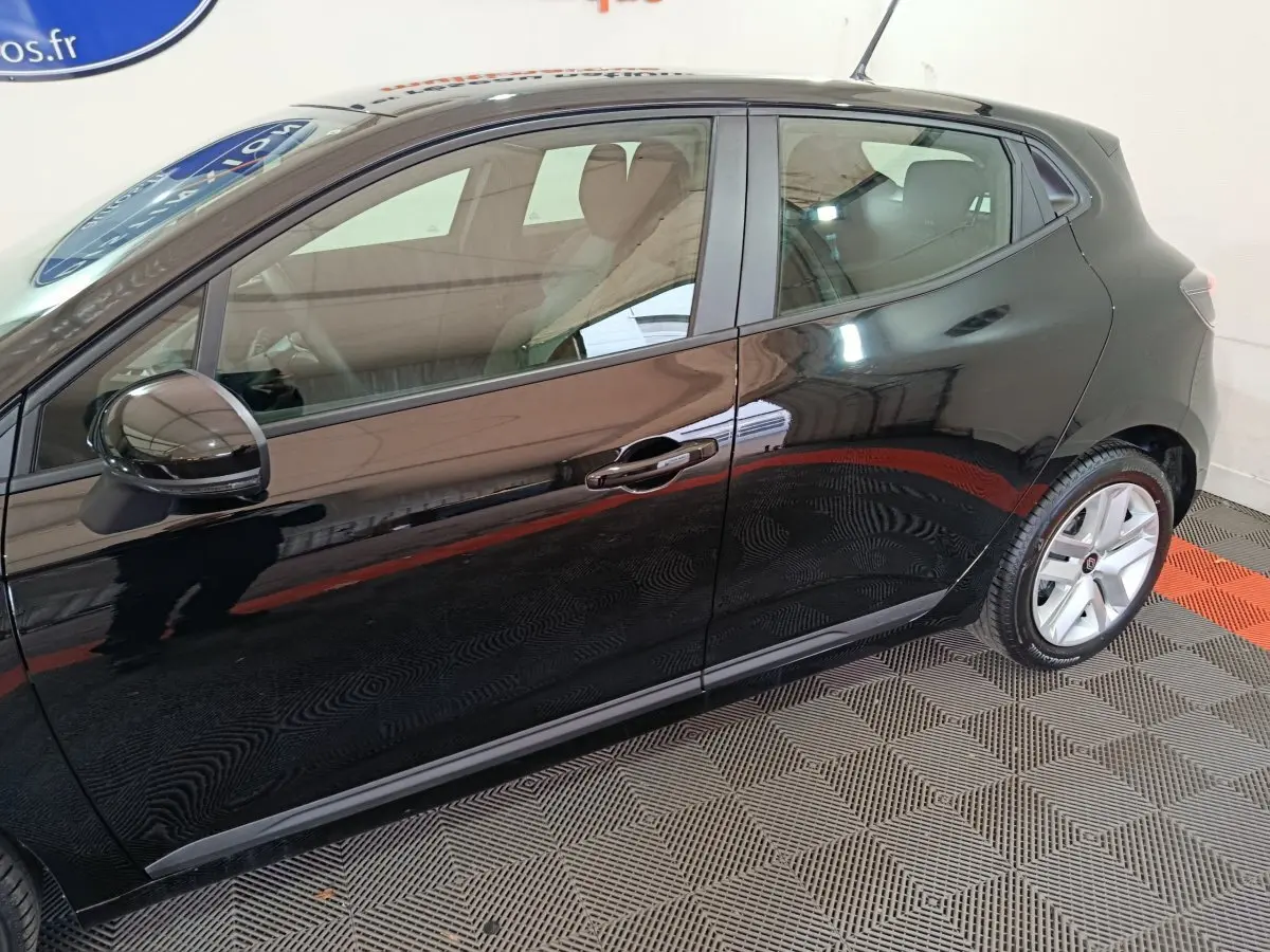 Profil droit d'une Renault Clio Evolution Blue dCi 100 noire, avec jantes alliage et rétroviseur ton caisse.