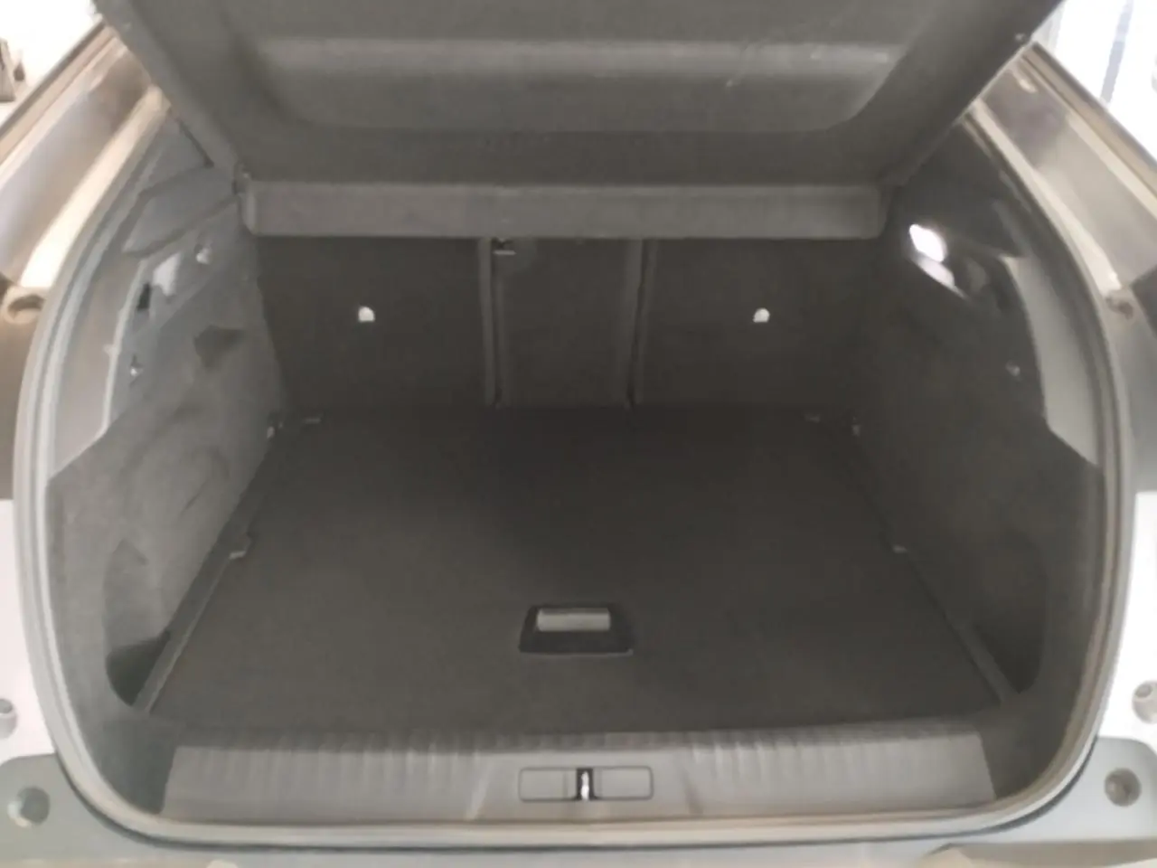Coffre ouvert du Peugeot 3008 gris Artense, montrant un espace de chargement spacieux et habillage intérieur sombre.