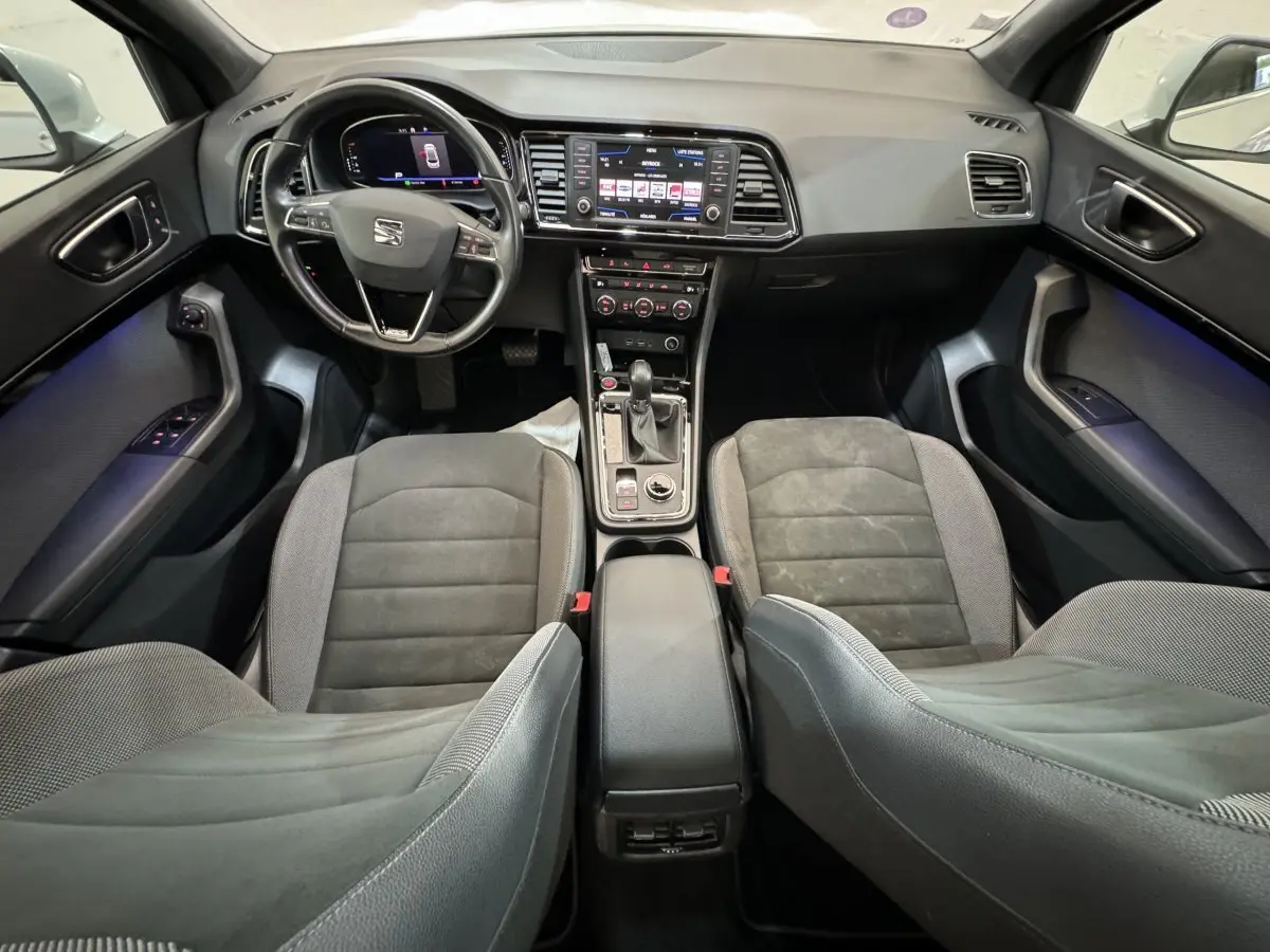 Vue intérieure avant du SEAT Ateca 2019, montrant tableau de bord digital, volant cuir, et sièges gris foncé.