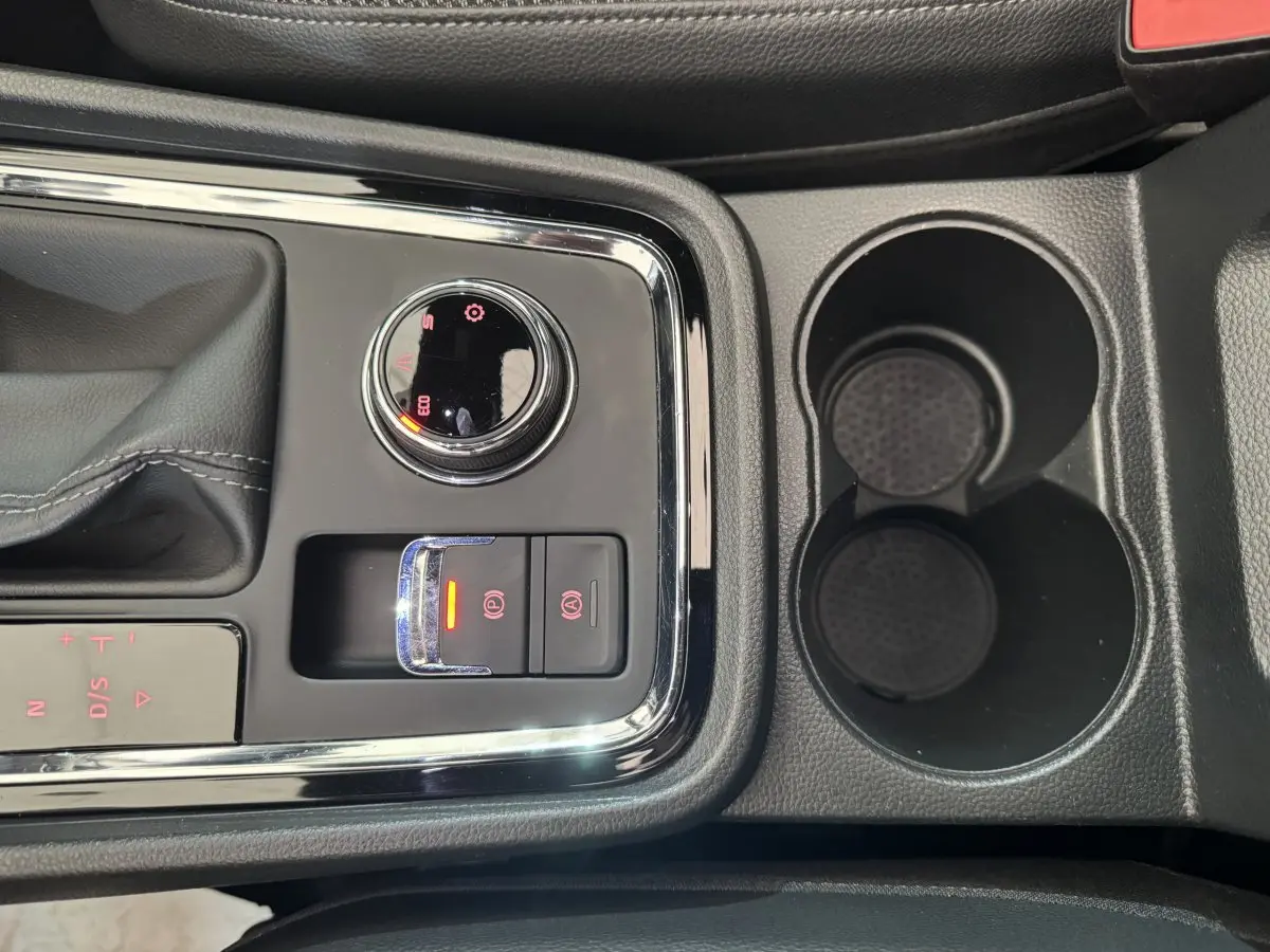 Gros plan sur la console centrale du SEAT Ateca gris clair 2019, avec sélecteur de mode de conduite et frein à main électrique.