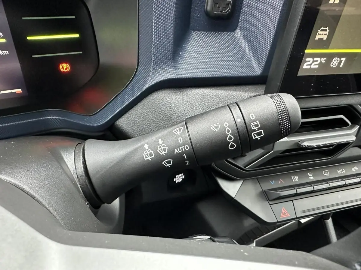 Gros plan sur la commande d’essuie-glace côté gauche du tableau de bord du Dacia Duster noir 2025.