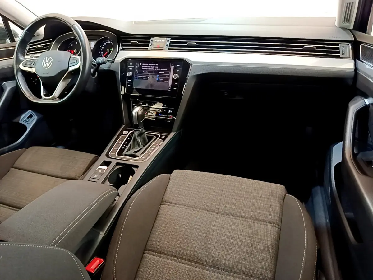Intérieur de Volkswagen Passat 2.0 TDI 2021, vue avant centrée sur tableau de bord et sièges tissu gris foncé.