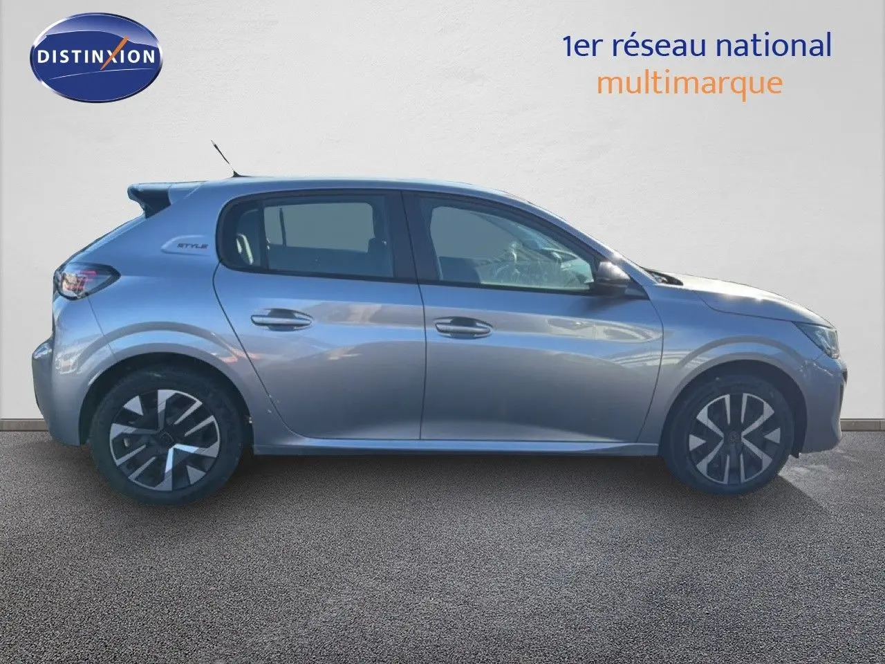 Profil côté gauche d'une Peugeot 208 1.2 Hybrid gris Artense métal avec jantes distinctives et badge Style visible.