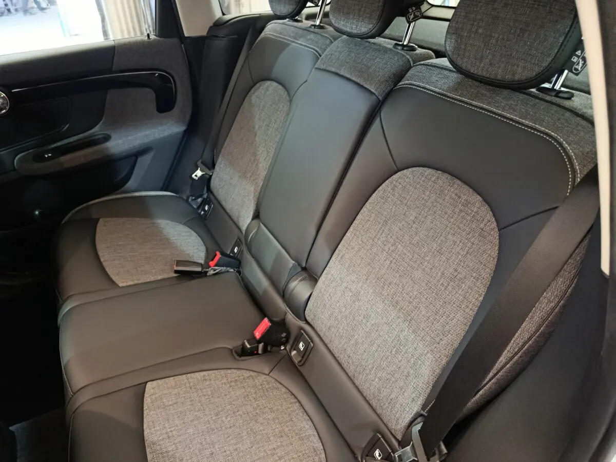 Vue intérieure côté droit des sièges arrière gris et noir du MINI COUNTRYMAN Cooper SE 2021, avec ceintures de sécurité visibles.