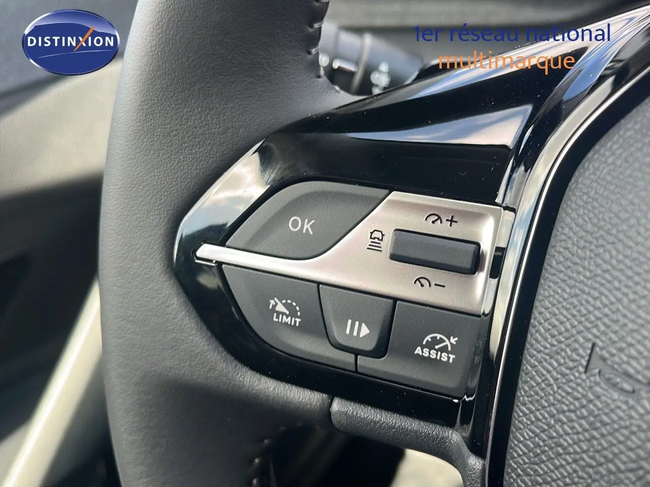 Gros plan sur les commandes au volant noir brillant de la Peugeot 308 1.2 Hybrid 136ch Allure 2024.