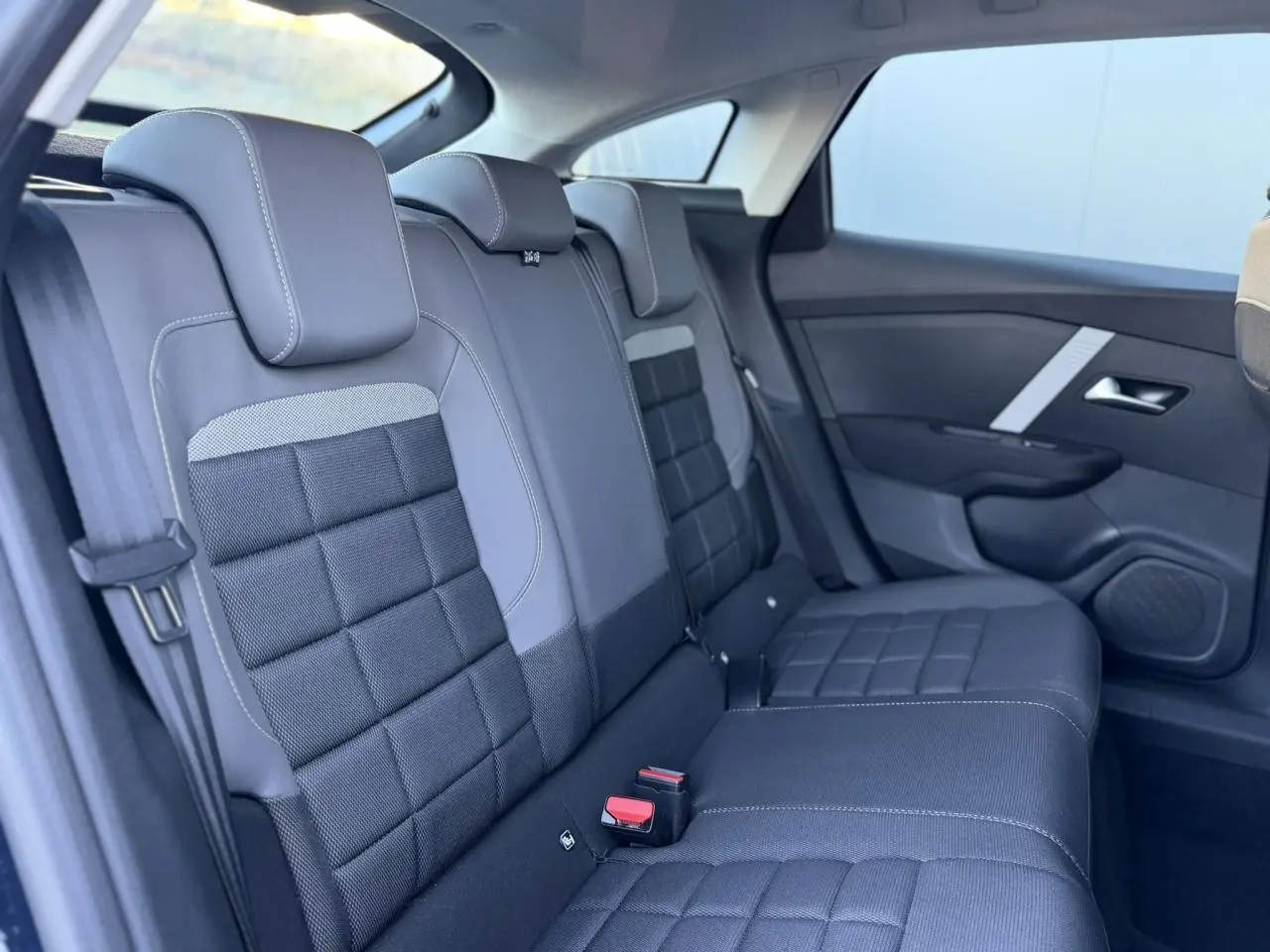 Vue intérieure côté droit des sièges arrière en tissu noir et gris de la Citroën C4 Hybrid 145 2025.