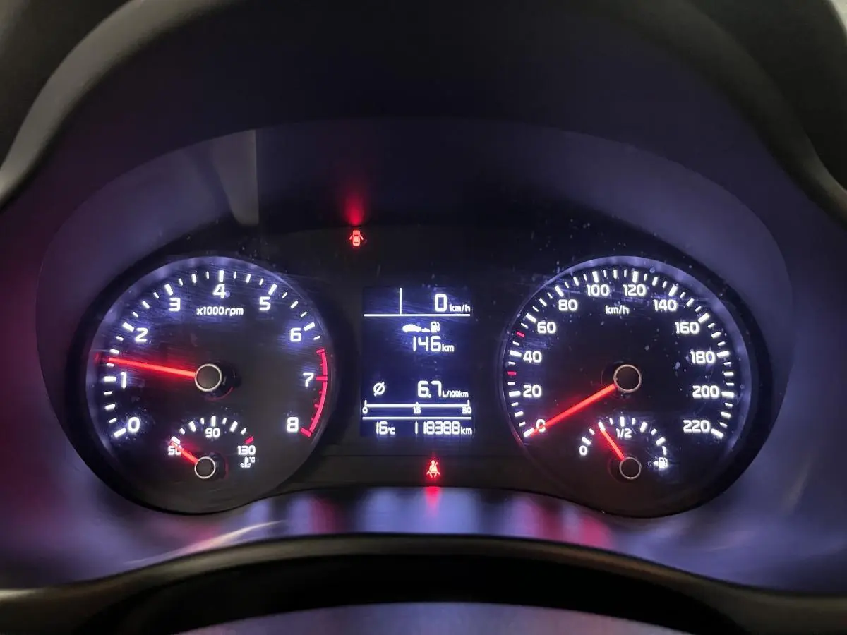 Vue rapprochée du tableau de bord du Kia Stonic blanc 2019 avec compte-tours et écran digital central allumé