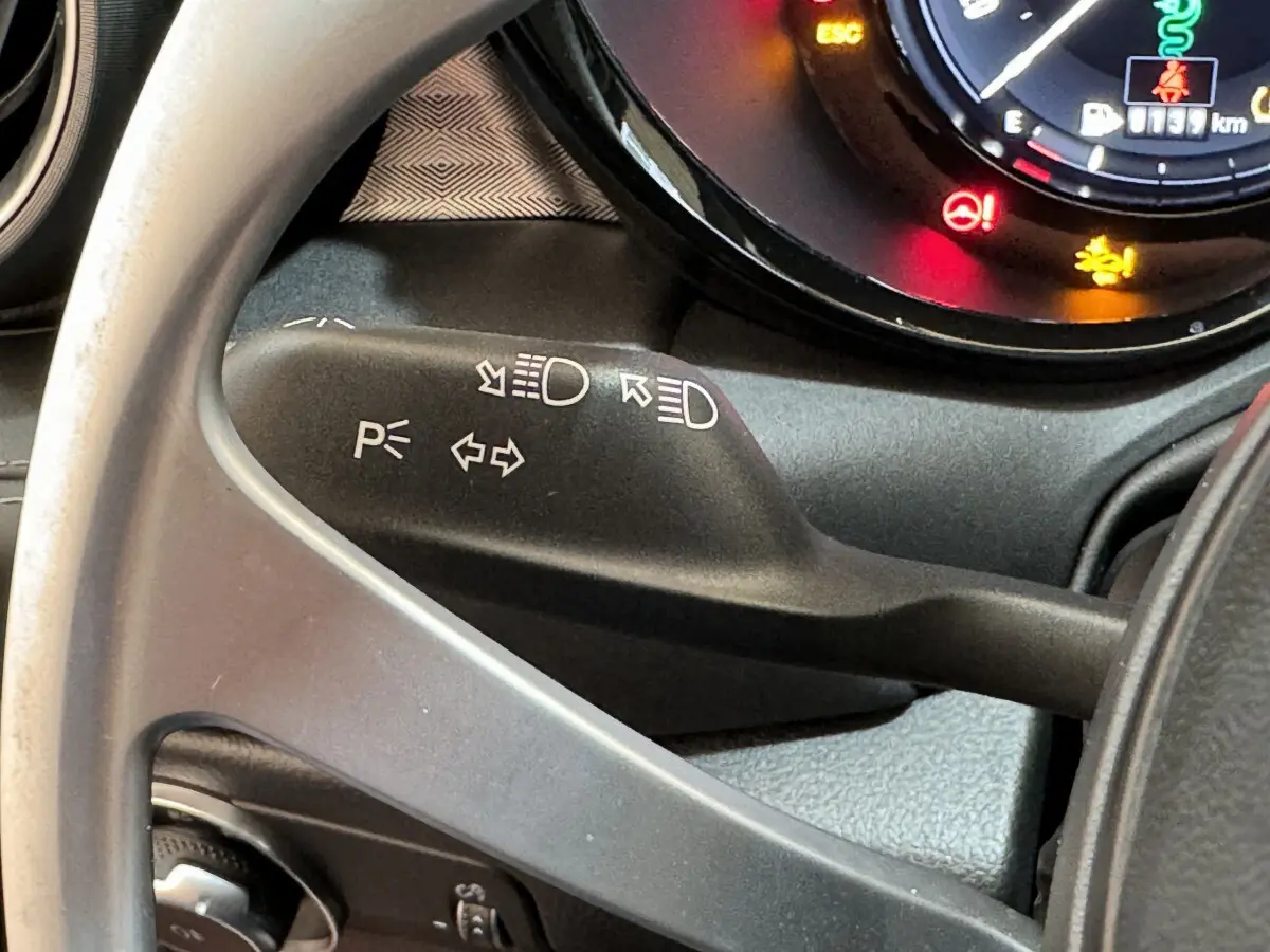 Gros plan sur la manette de clignotant noire et le tableau de bord partiel de l'Alfa Romeo Tonale 2023.