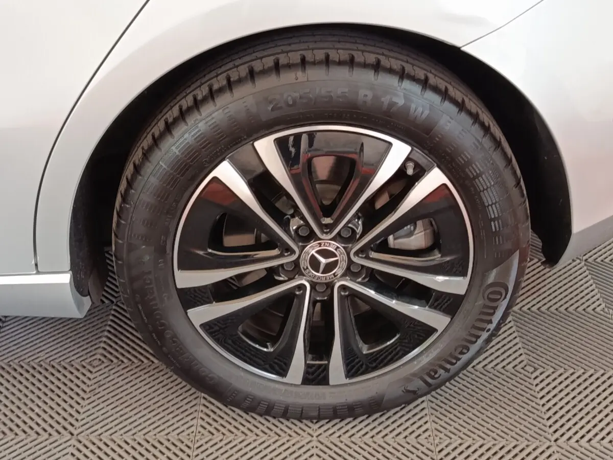Gros plan sur la roue arrière droite d’une Mercedes GLA 250 e Business Line gris foncé avec jante alliage noire et argent.