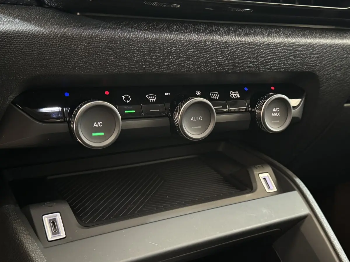 Gros plan sur les commandes de climatisation noire de la Citroën C4 PureTech 130 EAT8 Shine 2023.