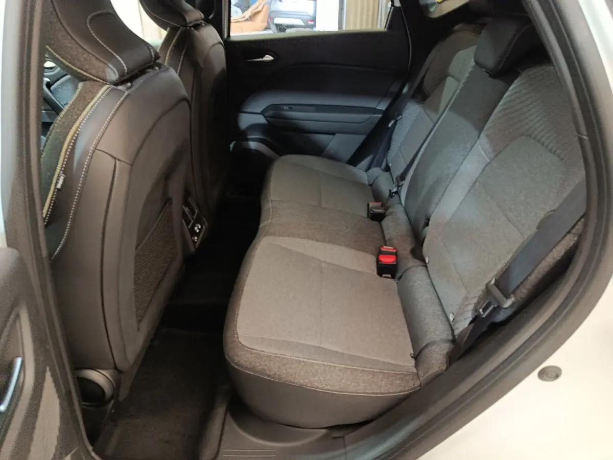 Vue intérieure côté droit des sièges arrière gris du Renault Captur blanc techno E-Tech full hybrid 145 2025.
