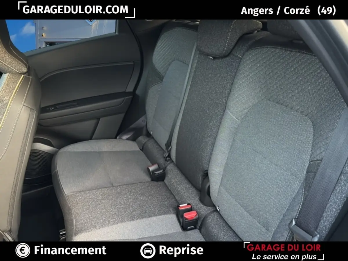 Vue intérieure côté arrière droit montrant les sièges tissu gris du Renault Captur techno TCe 90 2025.