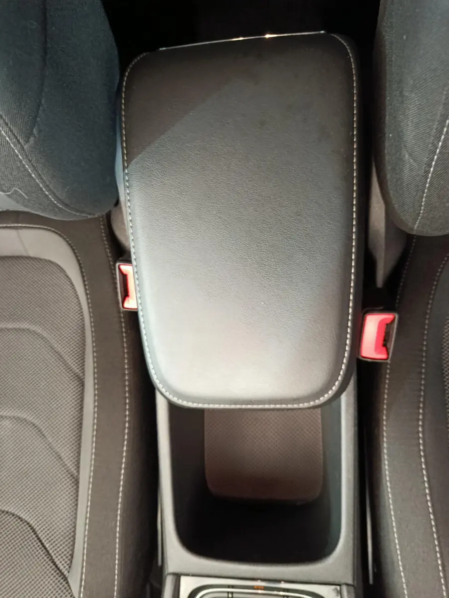 Vue plongeante sur l'accoudoir central noir et les sièges tissu gris du Skoda Kodiaq 2021 version Ambition.