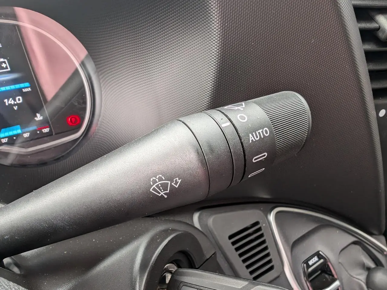 Gros plan sur la commande d'essuie-glace automatique dans l'habitacle du Iveco Daily blanc de 2025.