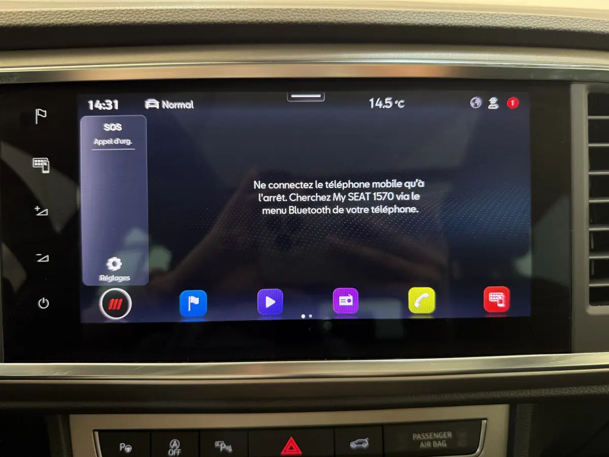 Écran tactile central du tableau de bord du SEAT Ateca gris clair, affichant la connexion Bluetooth et l'appel d'urgence.