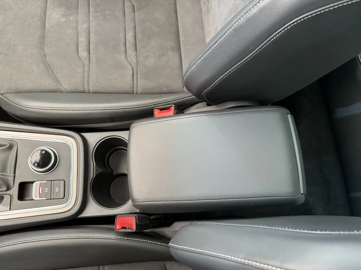 Gros plan sur la console centrale noire et les sièges en cuir gris foncé du SEAT Ateca 2023.