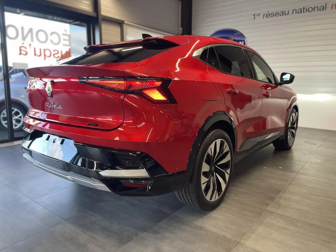 Vue 3/4 arrière droite du Renault Rafale rouge à toit noir avec feux arrière LED et jantes alliage noires.