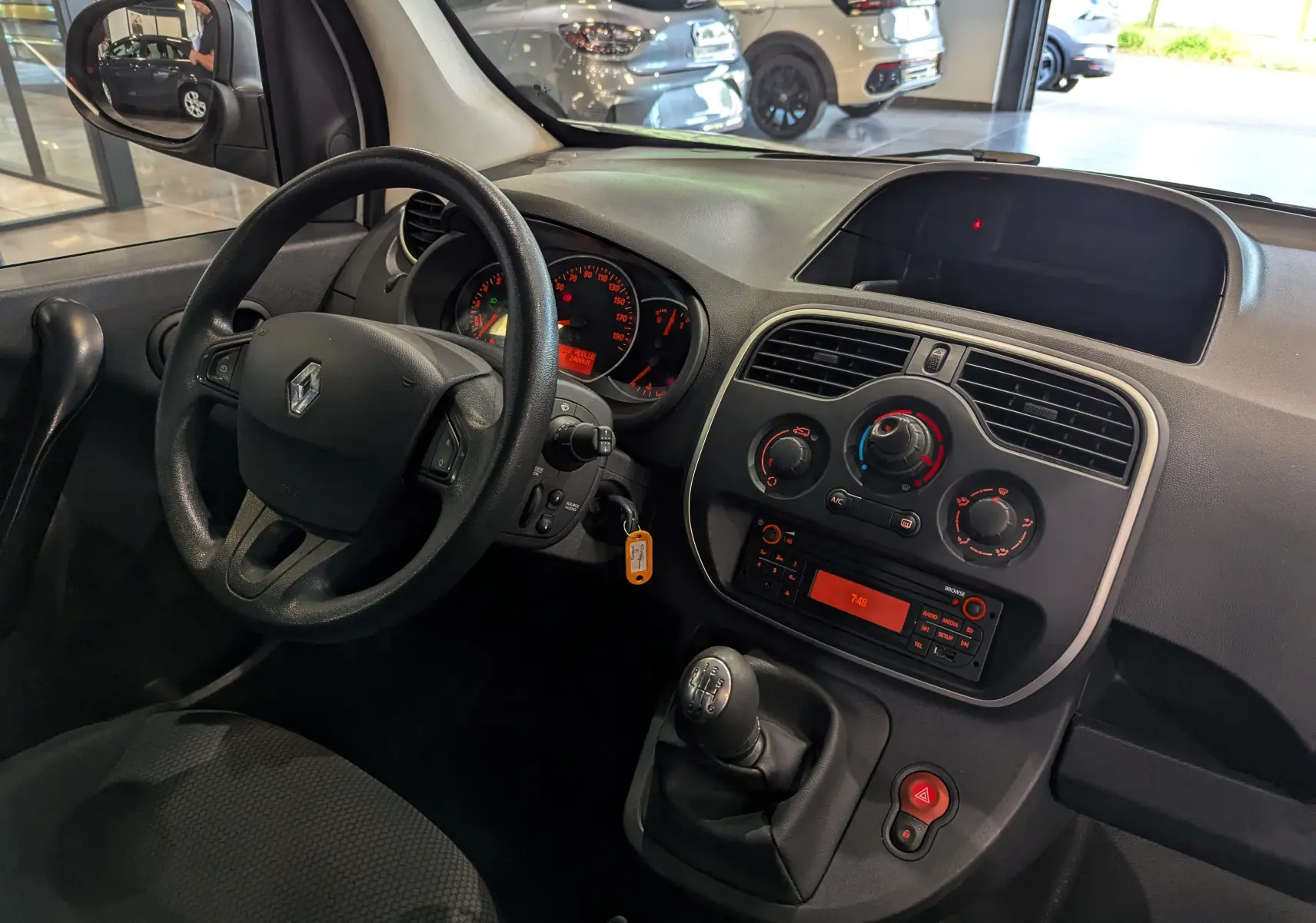 Vue intérieure côté conducteur du tableau de bord et volant noir du Renault Kangoo Express blanc 2021.