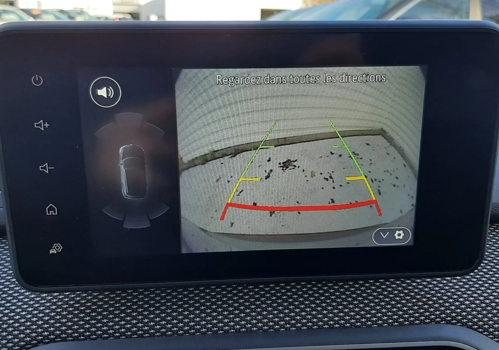 Écran central du Dacia Jogger montrant l'image de la caméra de recul avec lignes de guidage colorées.