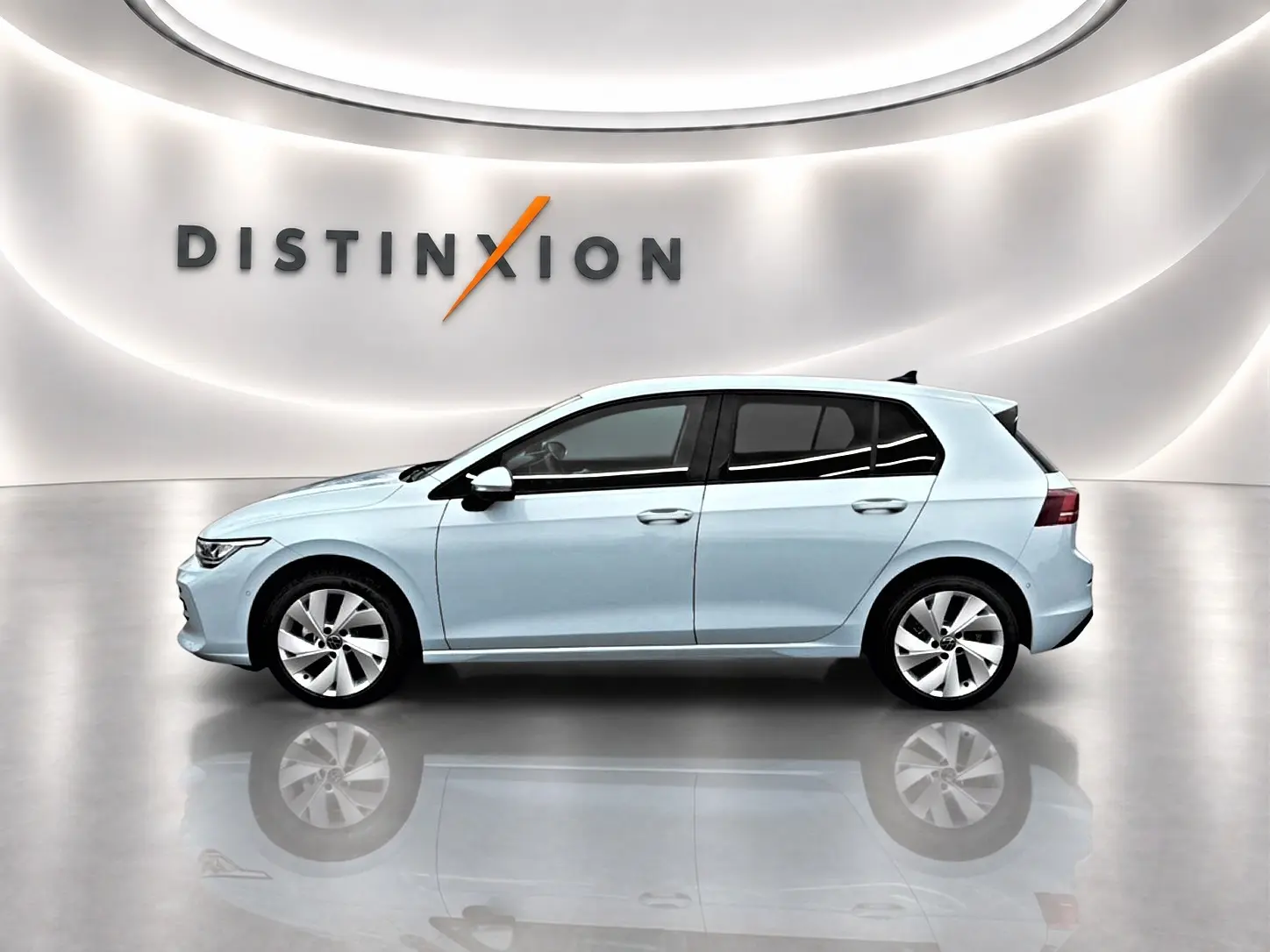 Volkswagen Golf 2026 bleu glacier vue de profil côté gauche dans un showroom lumineux avec reflet au sol.