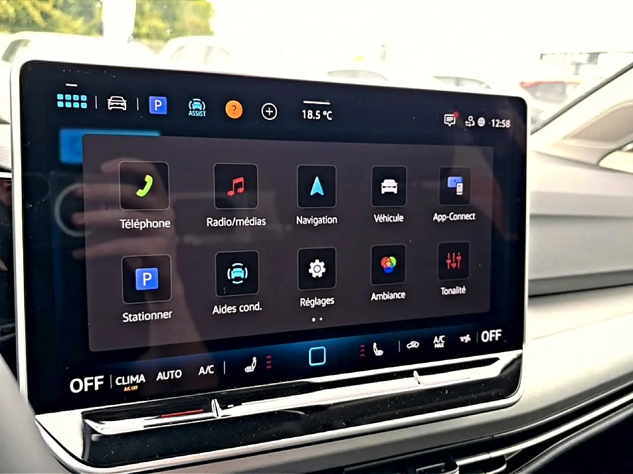 Vue rapprochée de l'écran tactile central du tableau de bord de la Volkswagen Golf noire 2026, affichant les menus multimédias et de réglages.