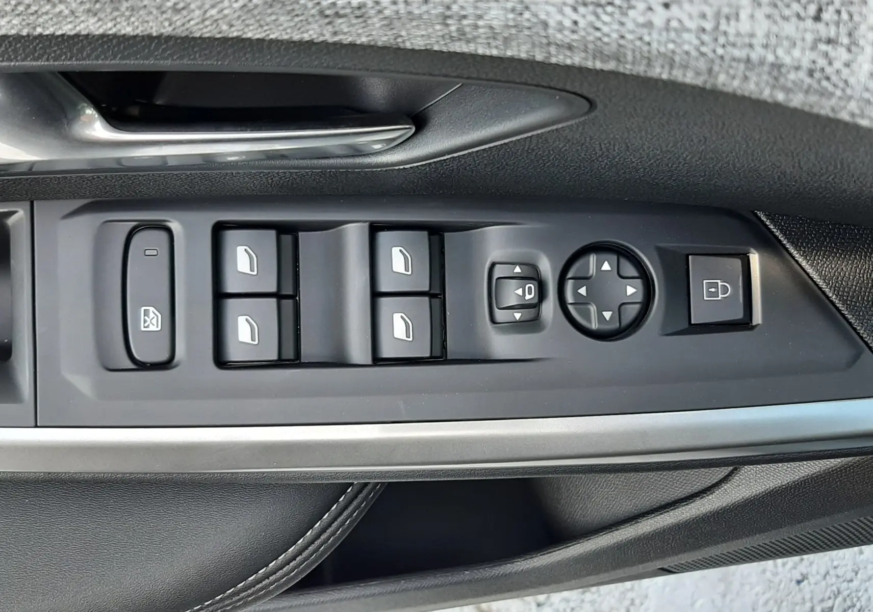 Panneau de commandes des vitres et rétroviseurs côté gauche intérieur du Peugeot 5008 bleu Ingaro 2025.
